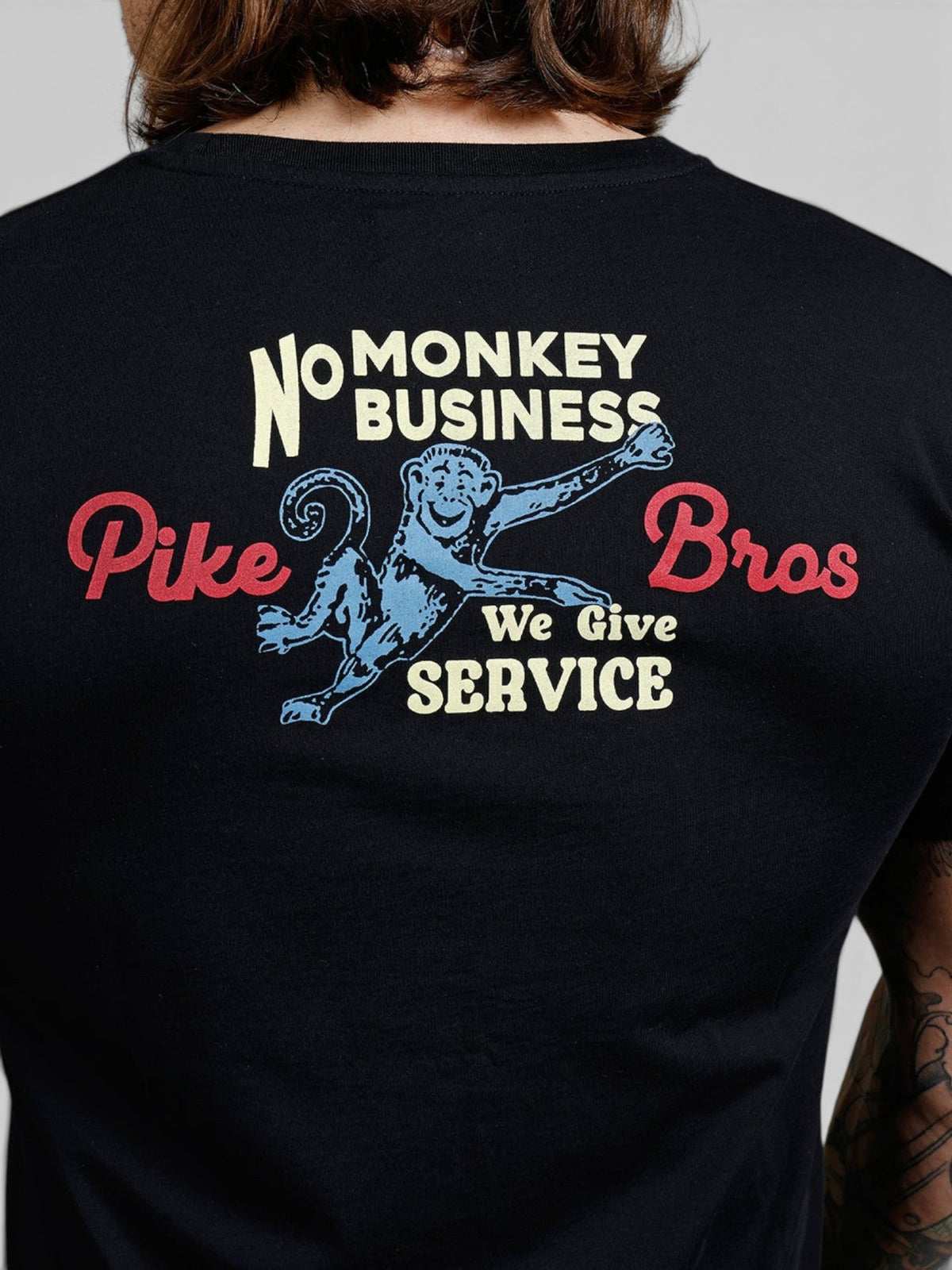 Baffle Haus black 100% cotton sports tee featuring a vintage 1960s style monkey graphic on the back