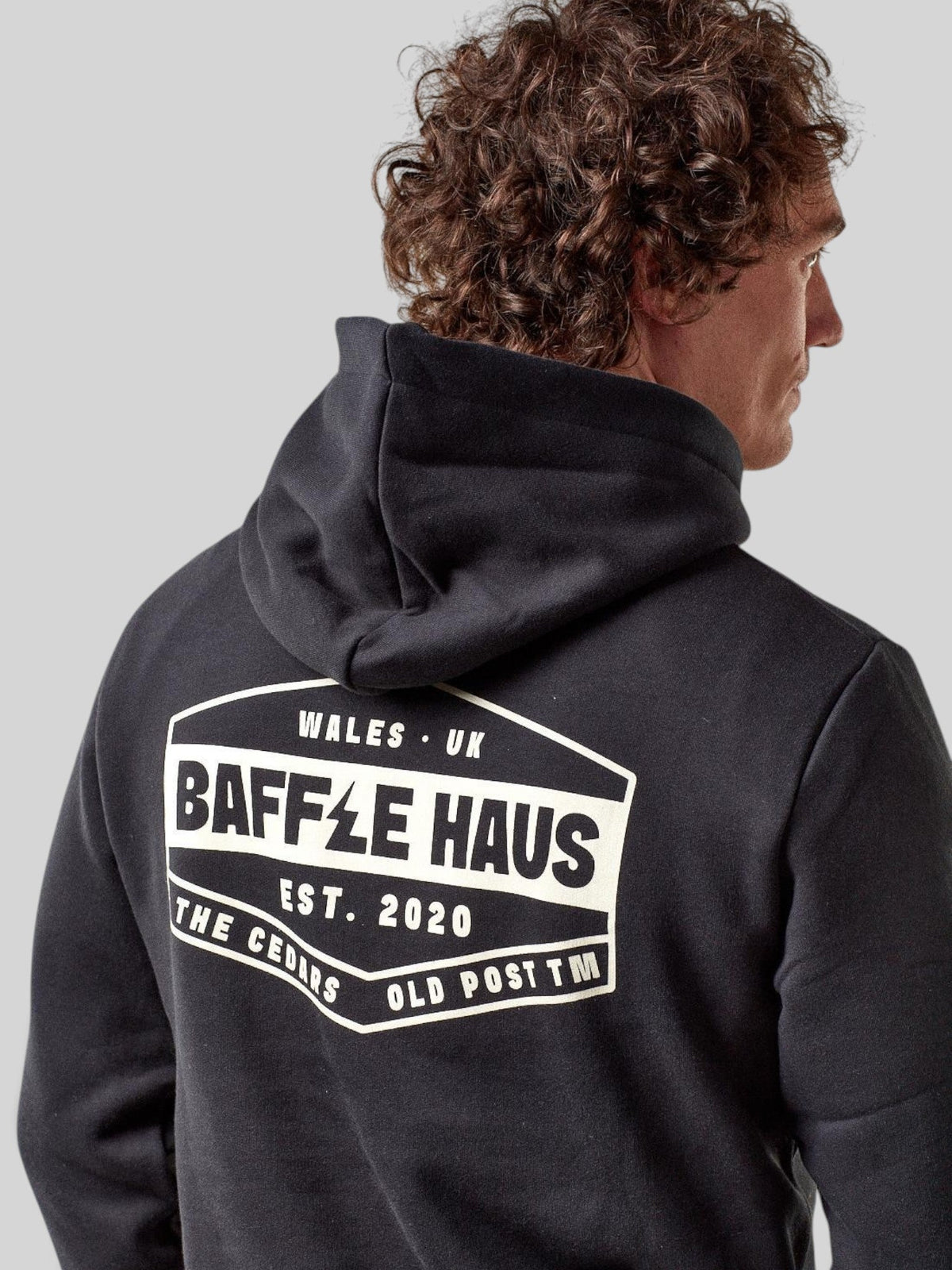 Baffle Haus jet black heavyweight cotton blend hoodie featuring a white graphic logo print on the back