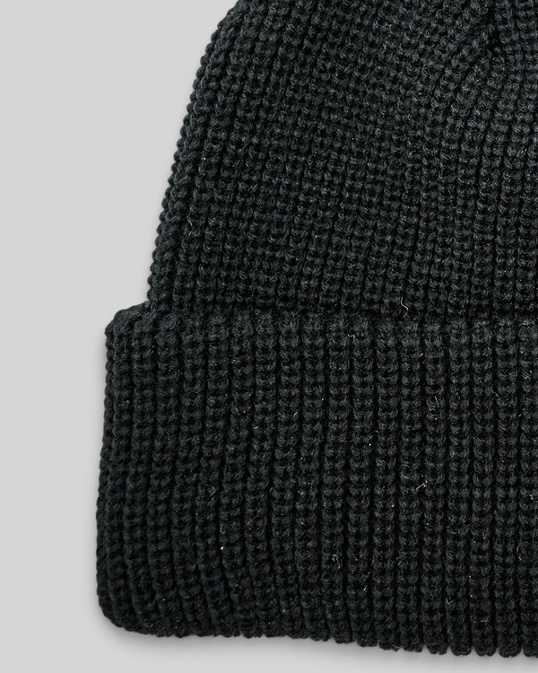 Baffle Haus black acrylic ribbed knit beanie with a classic cuffed design for everyday warmth.