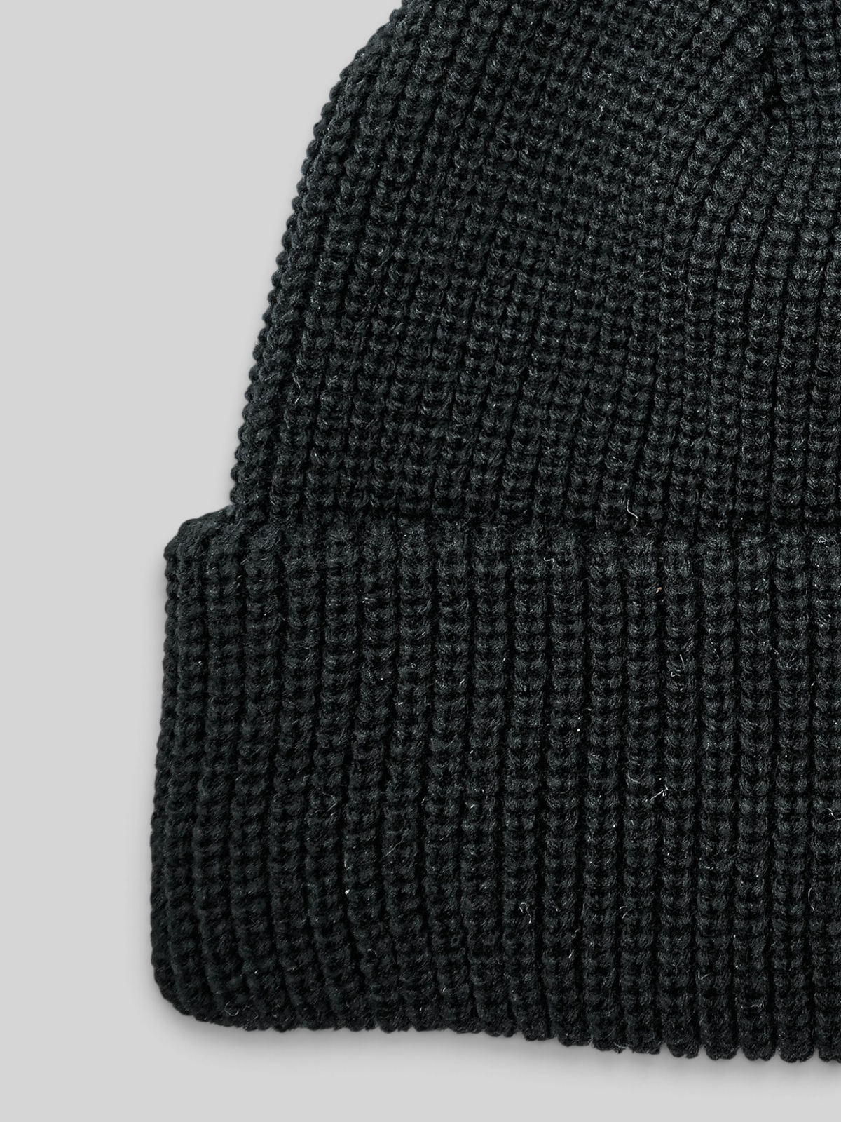 Baffle Haus black acrylic ribbed knit beanie with a classic cuffed design for everyday warmth.