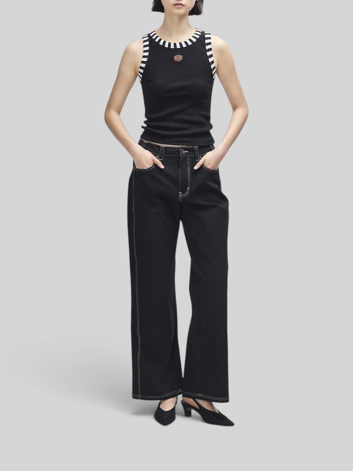 Baffle Haus black ribbed tank top with contrast stripe neck and armhole trim and small Deus shield embroidery