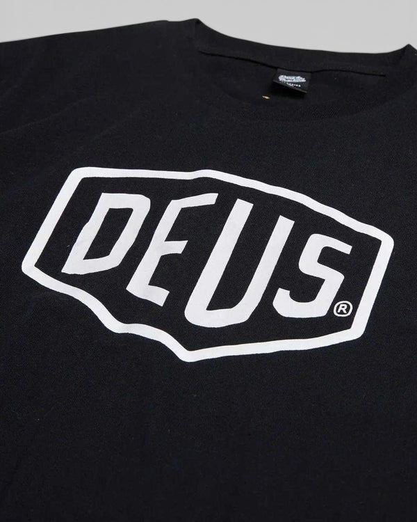 Baffle Haus black cotton jersey Shield Tee featuring a white Deus Ex Machina logo graphic on the chest