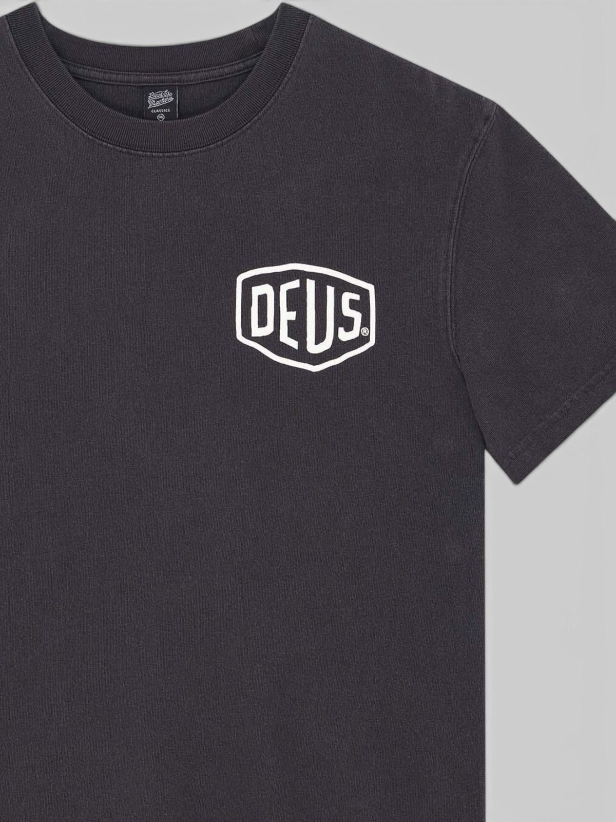 Baffle Haus black garment dyed heavyweight cotton t-shirt with white Deus shield logo print on the chest.
