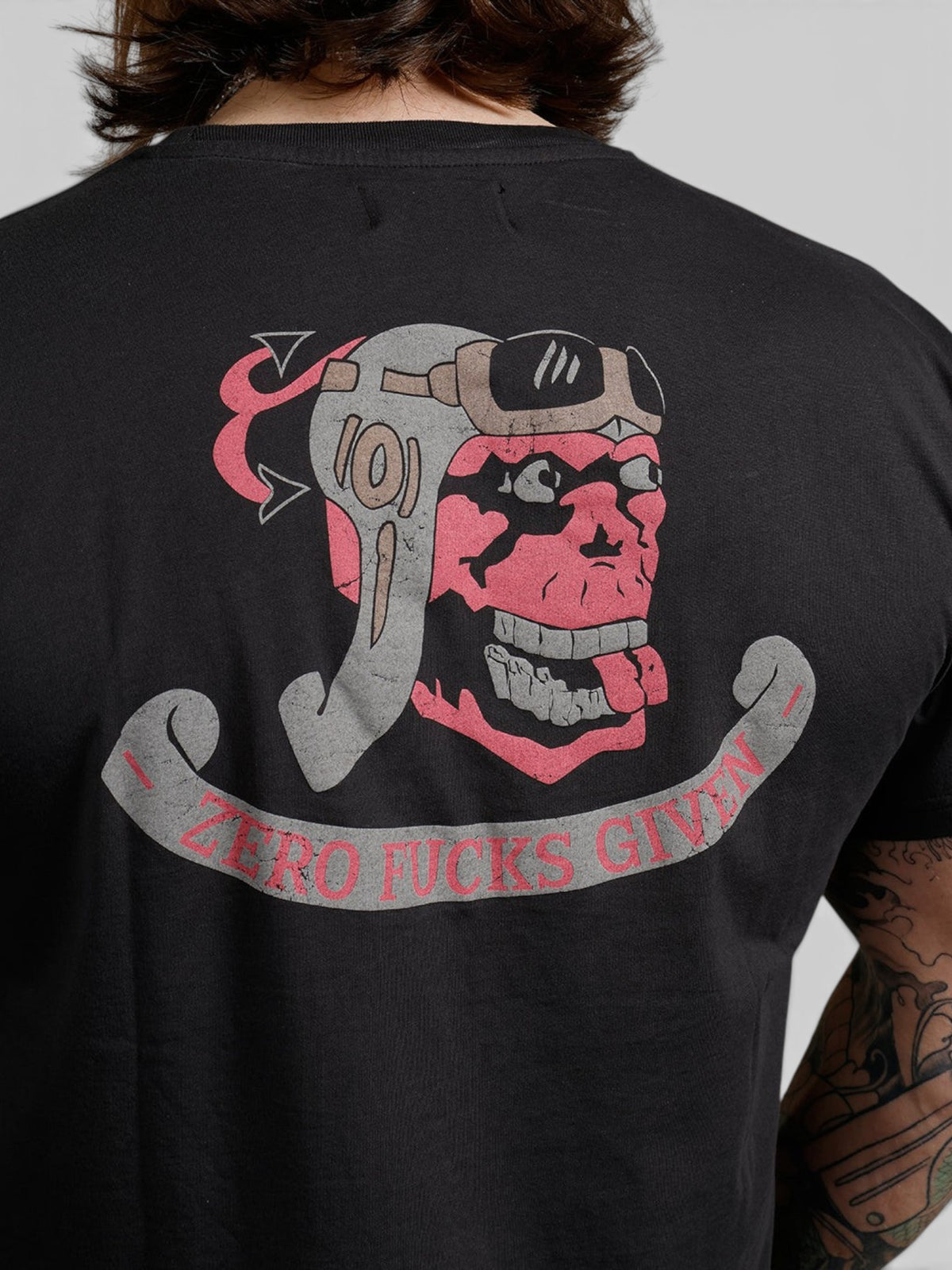 Baffle Haus black cotton t-shirt with a vintage-style skull pilot graphic print on the back