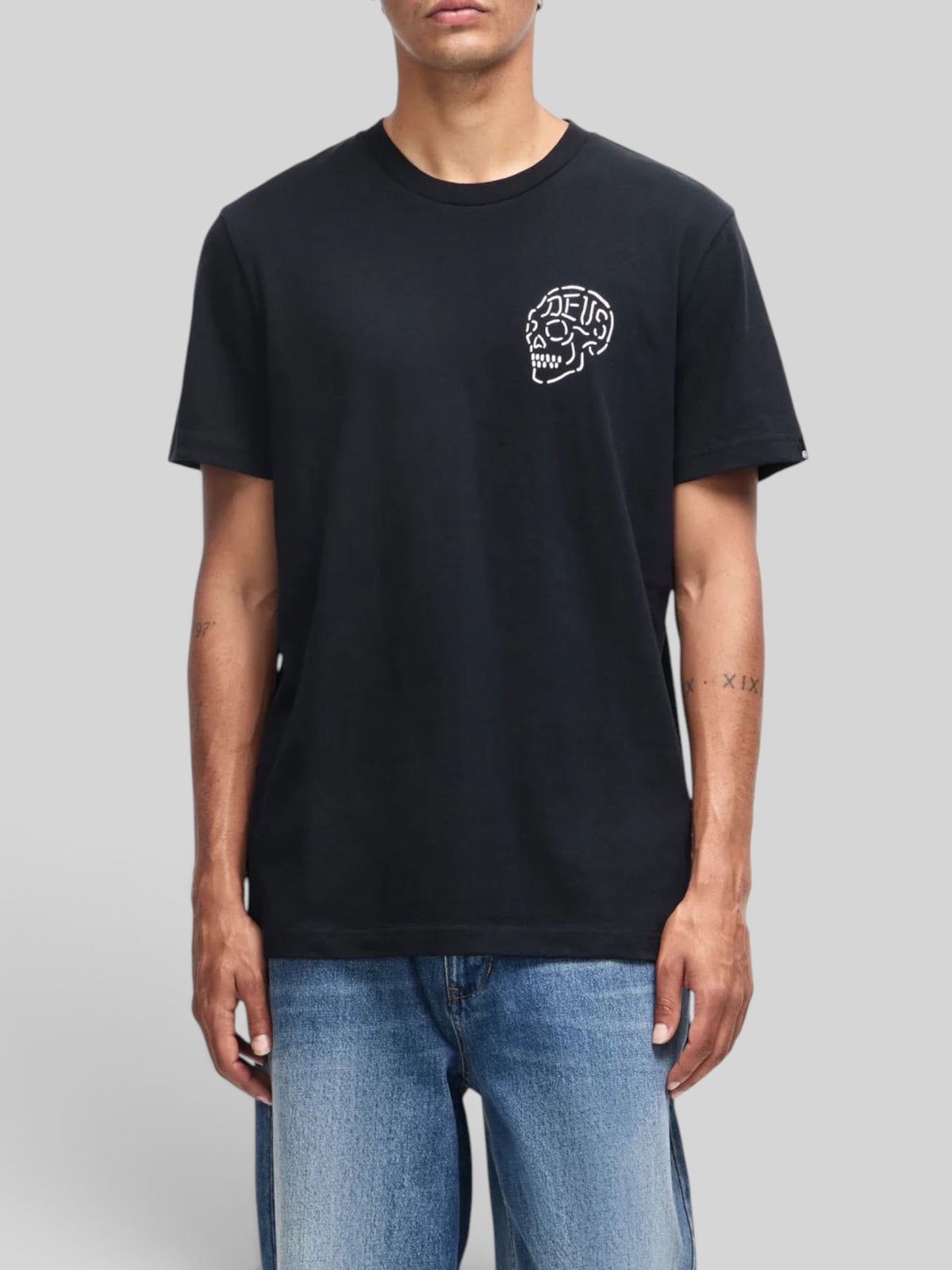 Baffle Haus Venice Skull Tee in black organic cotton with a small white skull graphic on the chest