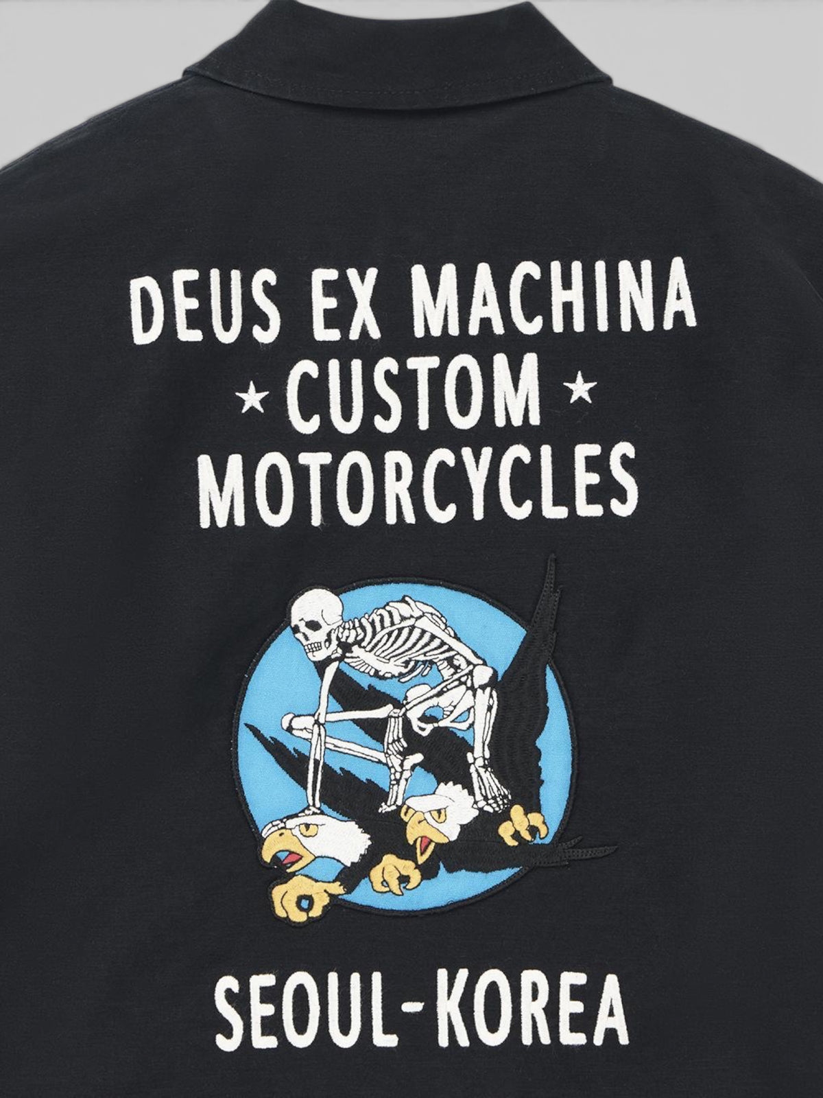 Baffle Haus black souvenir jacket featuring embroidered skeleton and eagle artwork on the back