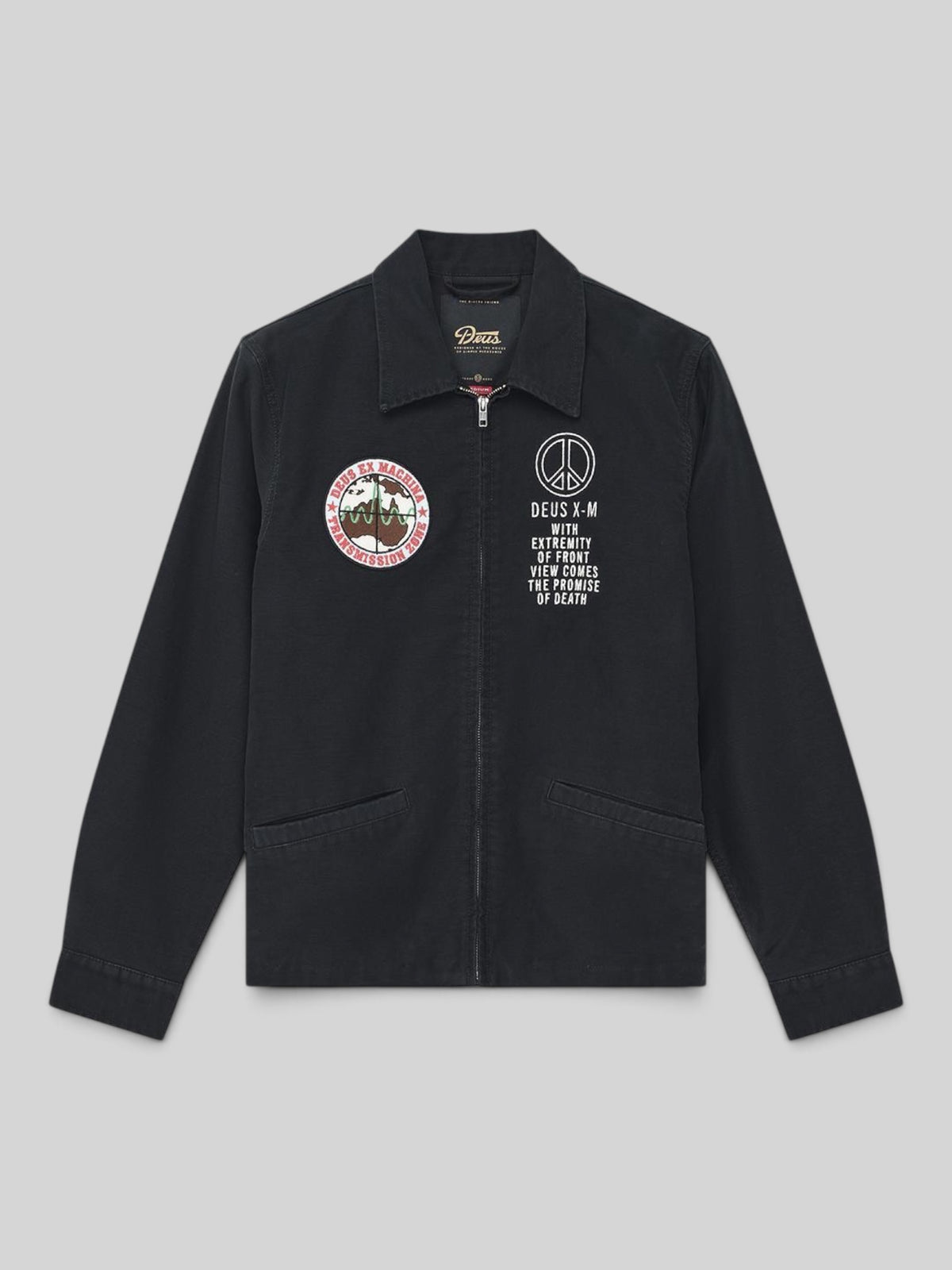 Baffle Haus black organic cotton sateen souvenir jacket with embroidered chest patches and zip front closure.