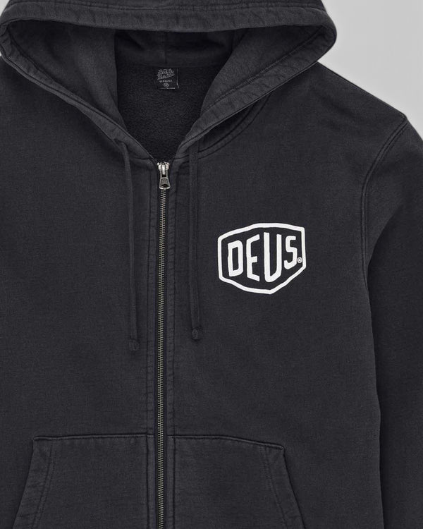 Baffle Haus black garment dyed zip hoodie featuring an embroidered white Deus shield logo on the chest