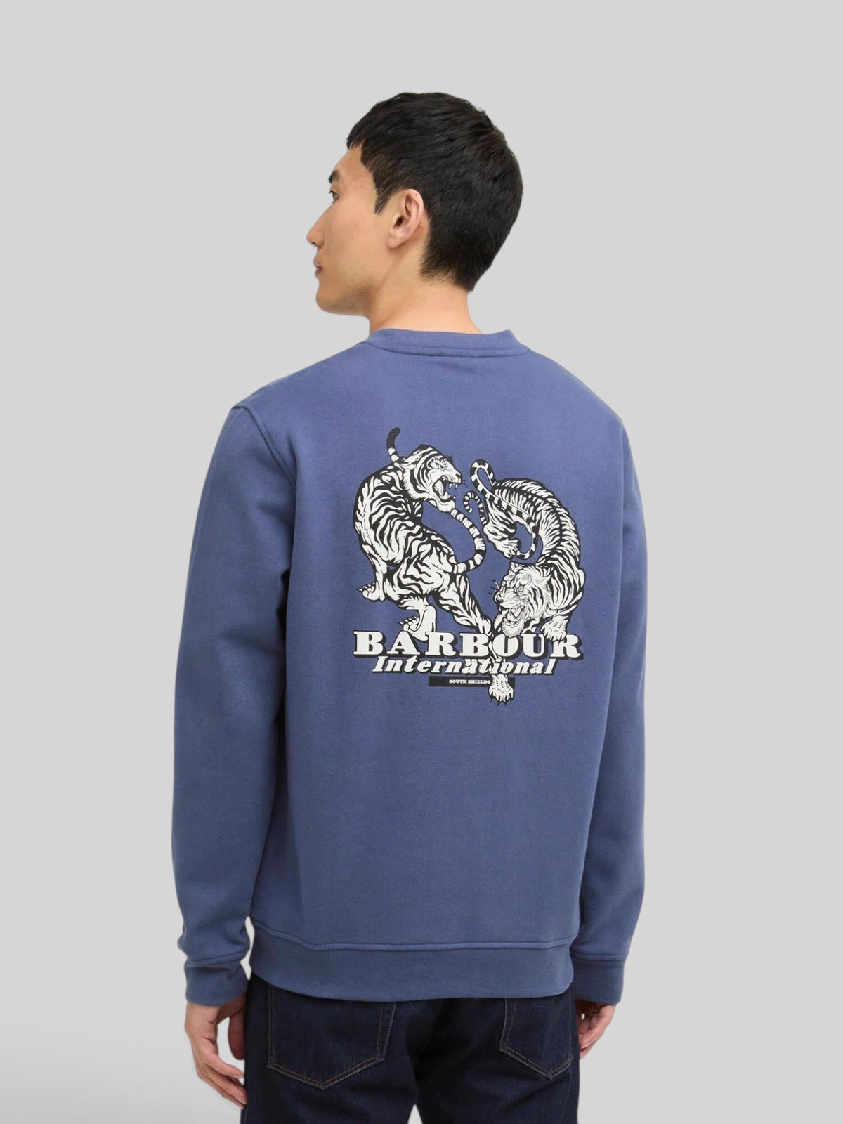Baffle Haus B.Intl Talisman blue cotton sweatshirt with tiger graphic print on the back, worn by a male model.