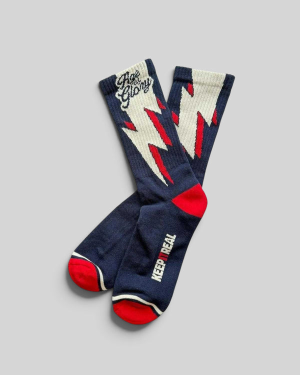 Baffle Haus Age of Glory blue cotton socks with white and red lightning bolt graphic and Keep It Real text