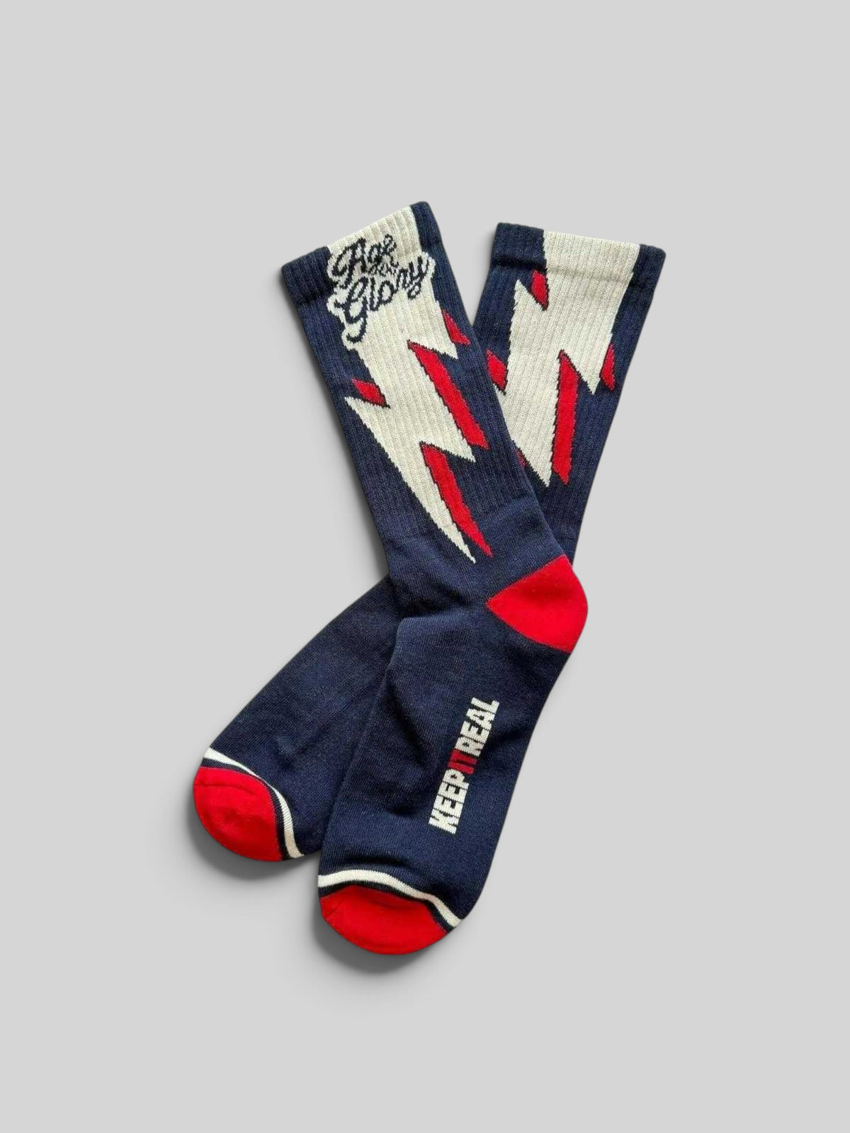 Baffle Haus Age of Glory blue cotton socks with white and red lightning bolt graphic and Keep It Real text