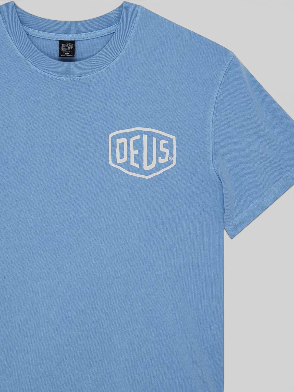 Baffle Haus Deus Shield garment dyed t-shirt in Bonnie Blue with a white printed chest logo on recycled cotton jersey.