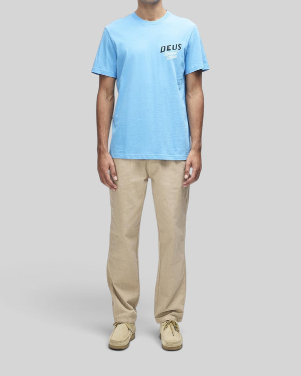 Baffle Haus Dogleg Tee in Bonnie Blue with Deus Speed Shop chest print, made from recycled and organic cotton jersey.