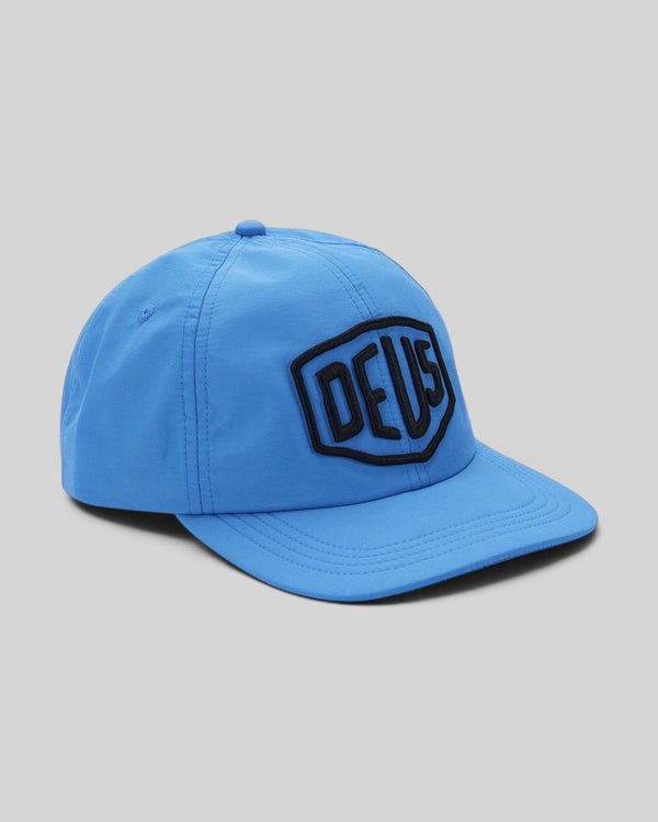 Baffle Haus Bonnie Blue nylon unstructured mid crown cap with a black shield logo patch on the front