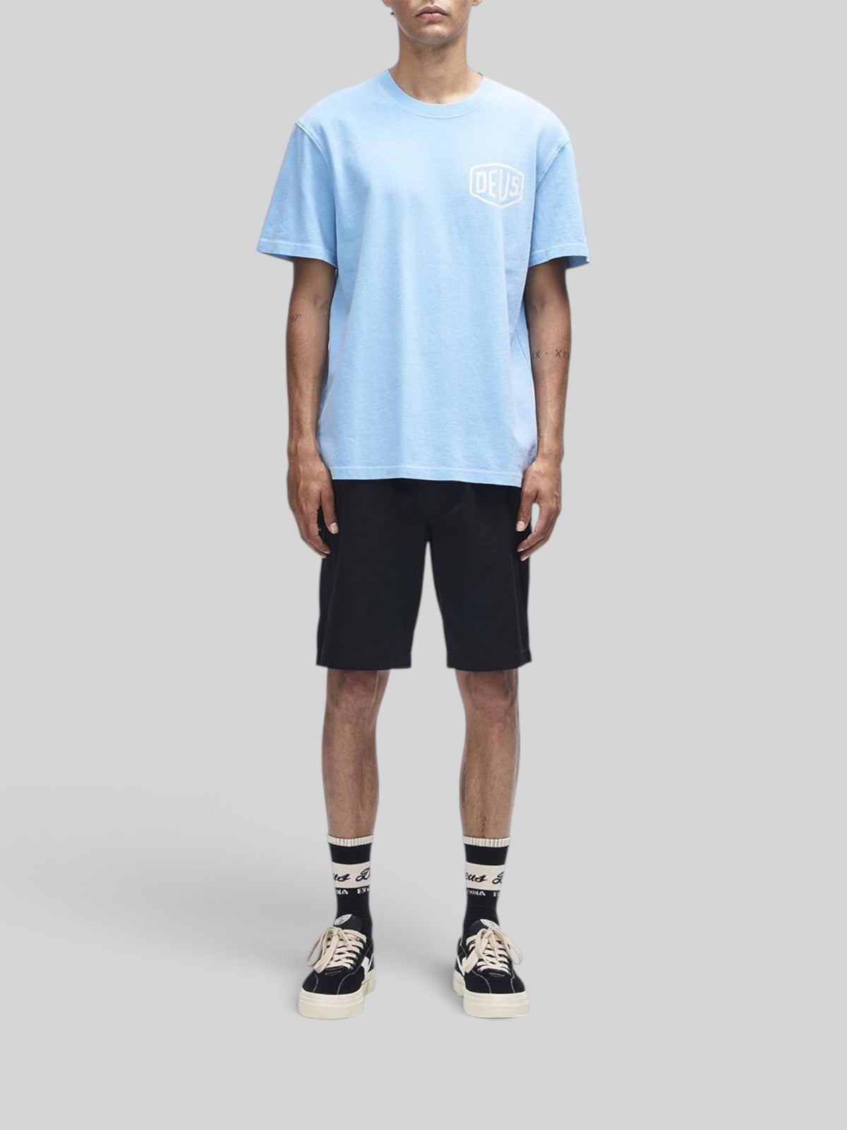 Baffle Haus Deus Shield garment dyed box fit t-shirt in Bonnie Blue with white chest logo on a male model