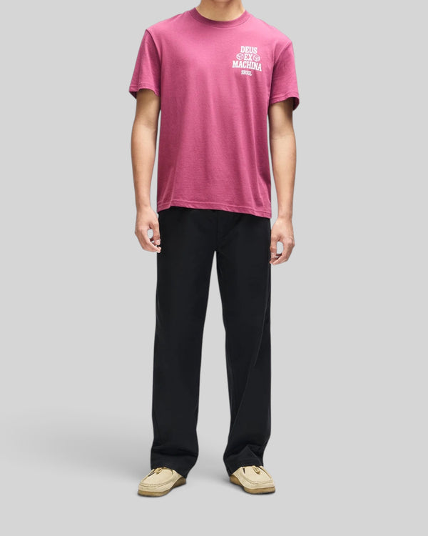Baffle Haus burgundy box fit cropped tee with white chest graphic, worn by a model with black trousers.