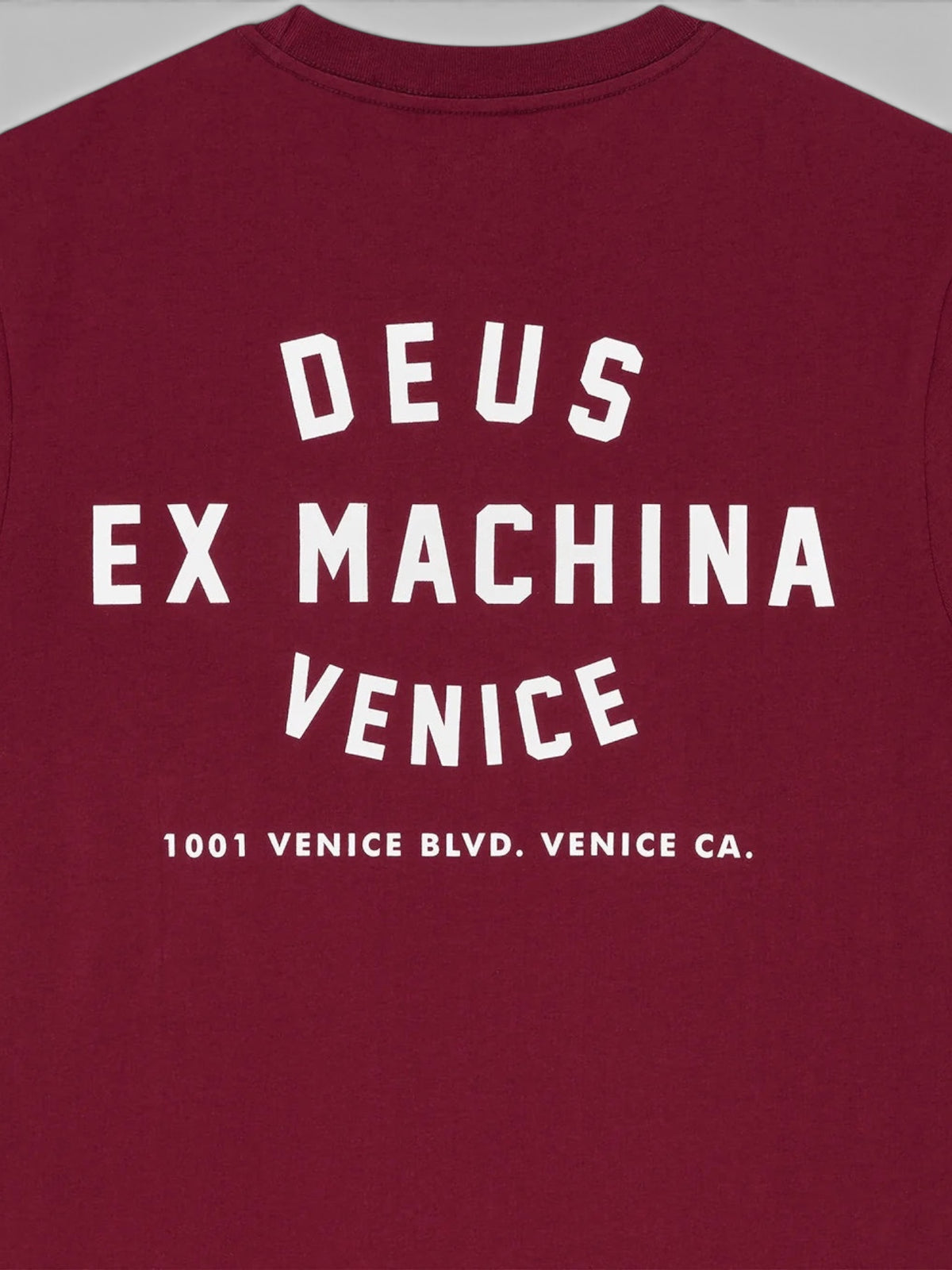 Baffle Haus burgundy organic cotton t-shirt featuring white Deus Ex Machina Venice address graphic on the back
