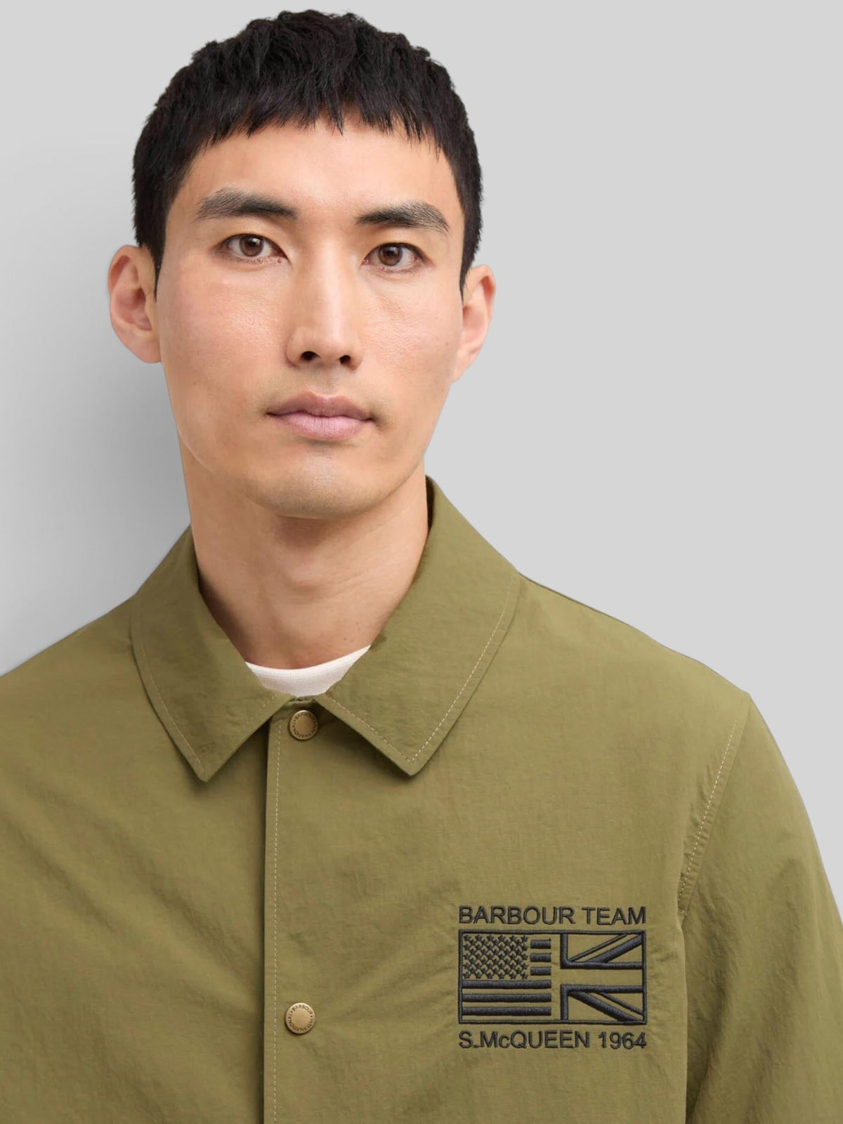 Baffle Haus International Coach Casual Jacket in burnt olive with Steve McQueen embroidery and stud front fastening.