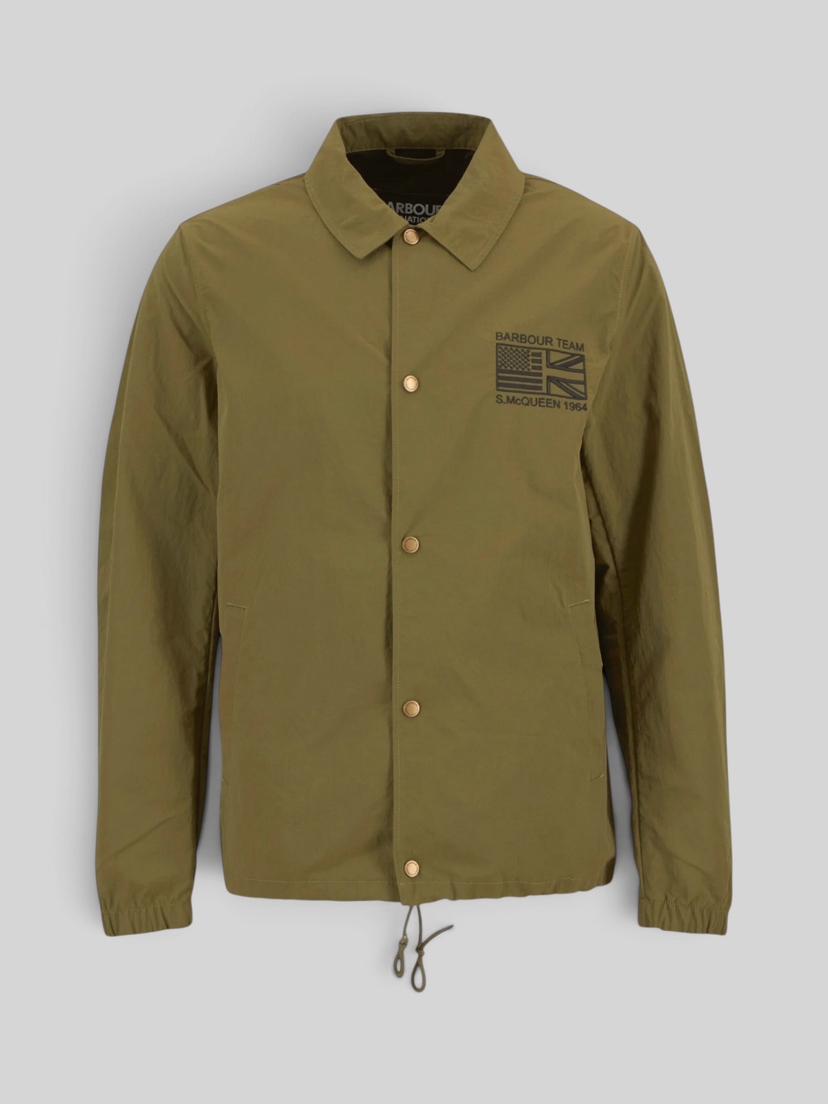 Baffle Haus International Coach casual jacket in burnt olive with stud front fastening and Steve McQueen embroidery.