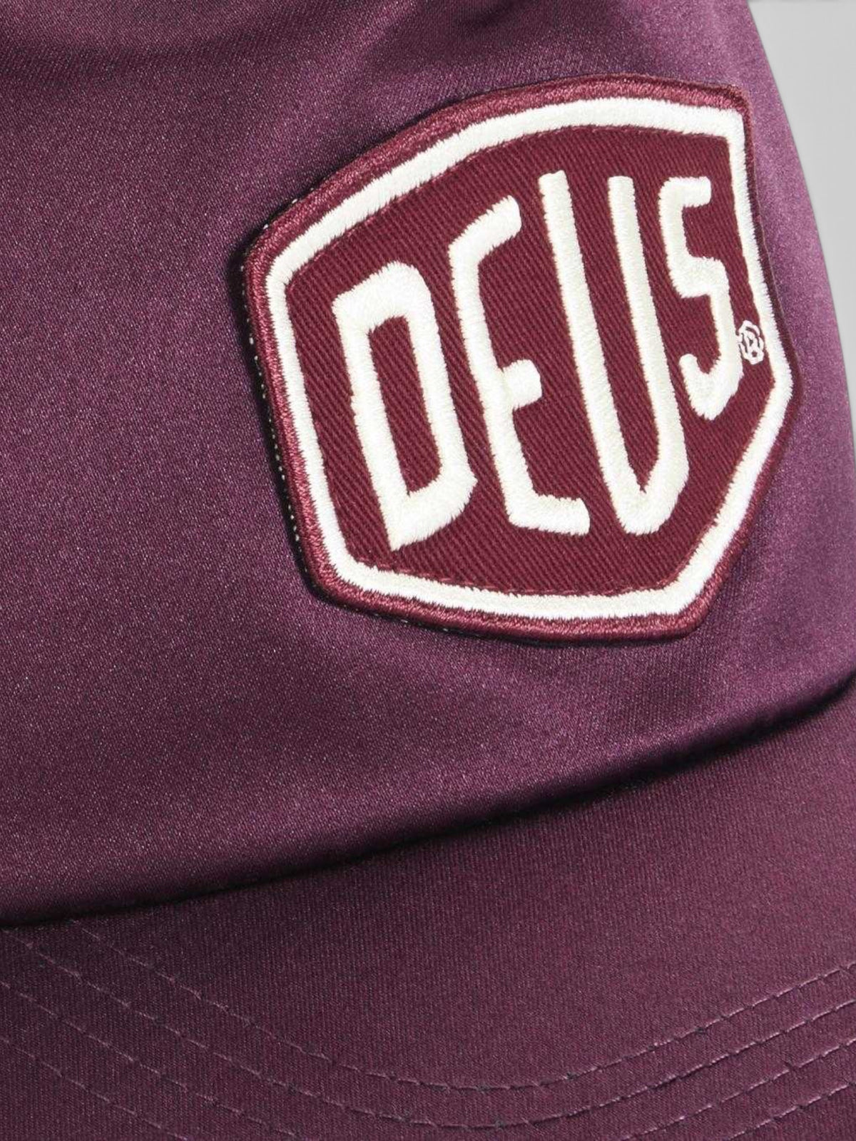 Baffle Haus Paris Shield trucker cap in cabernet red satin with a tonal woven logo patch on the front panel