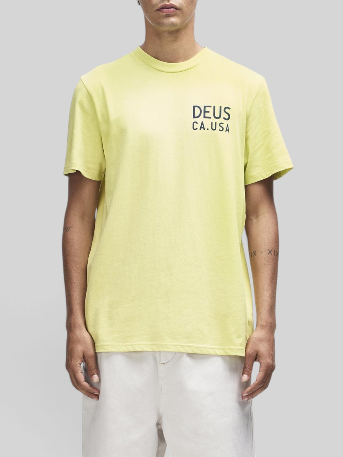 Baffle Haus Camber Tee in canary yellow featuring a black Deus CA.USA chest print on recycled and organic cotton