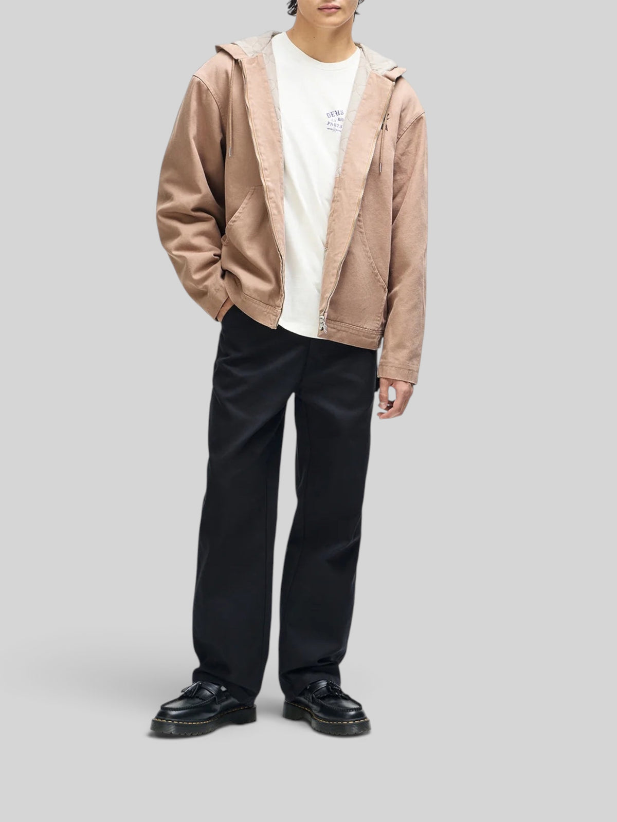 Baffle Haus camel brown cotton canvas hooded work jacket with zip front and embroidered details worn by a model