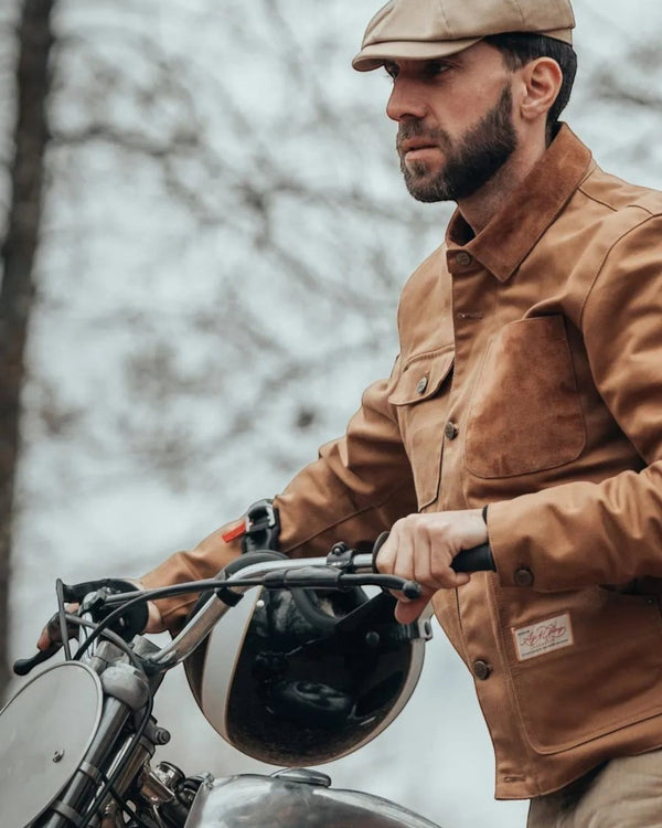 Baffle Haus Craftsman Jacket in caramel worn by a man on a vintage motorcycle, featuring durable workwear style.