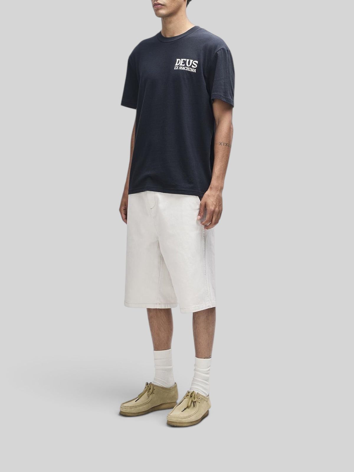 Baffle Haus Chinook black box fit t-shirt with white chest logo print worn by a model with white shorts