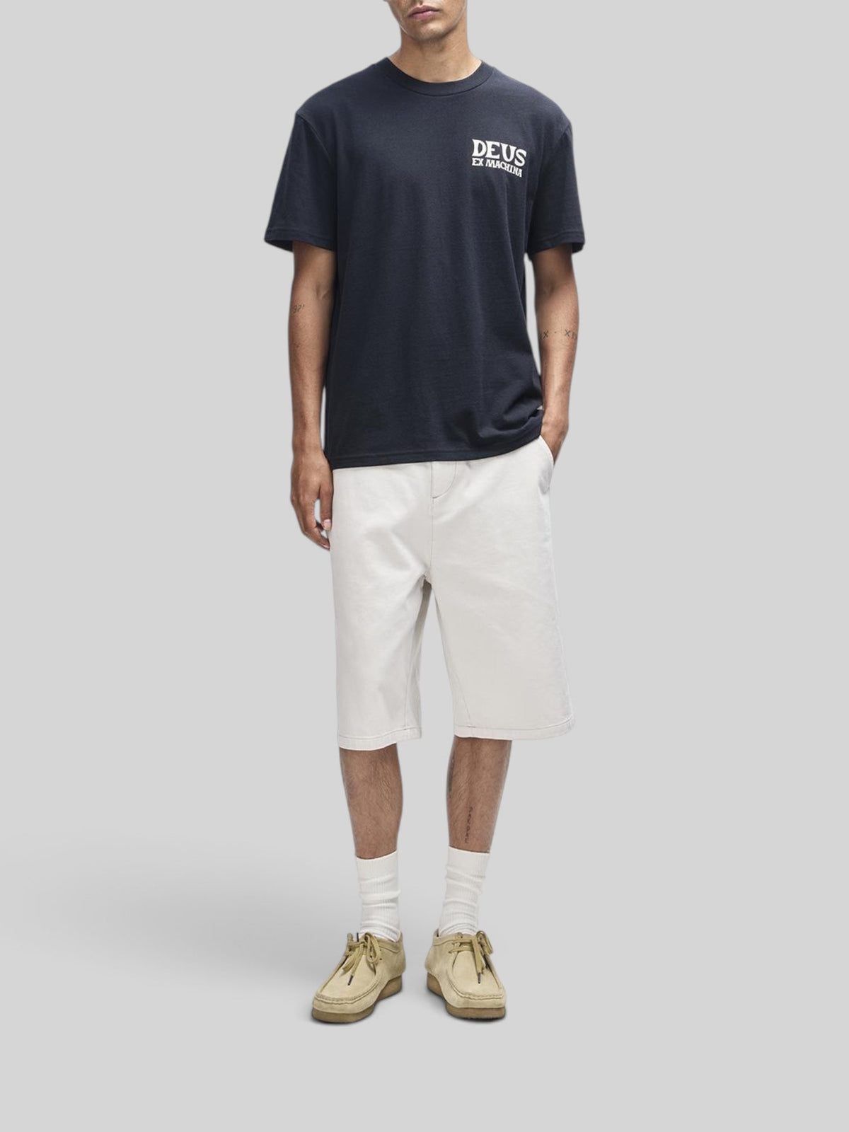 Baffle Haus Chinook black box fit t-shirt with white chest logo print worn by a model with light shorts