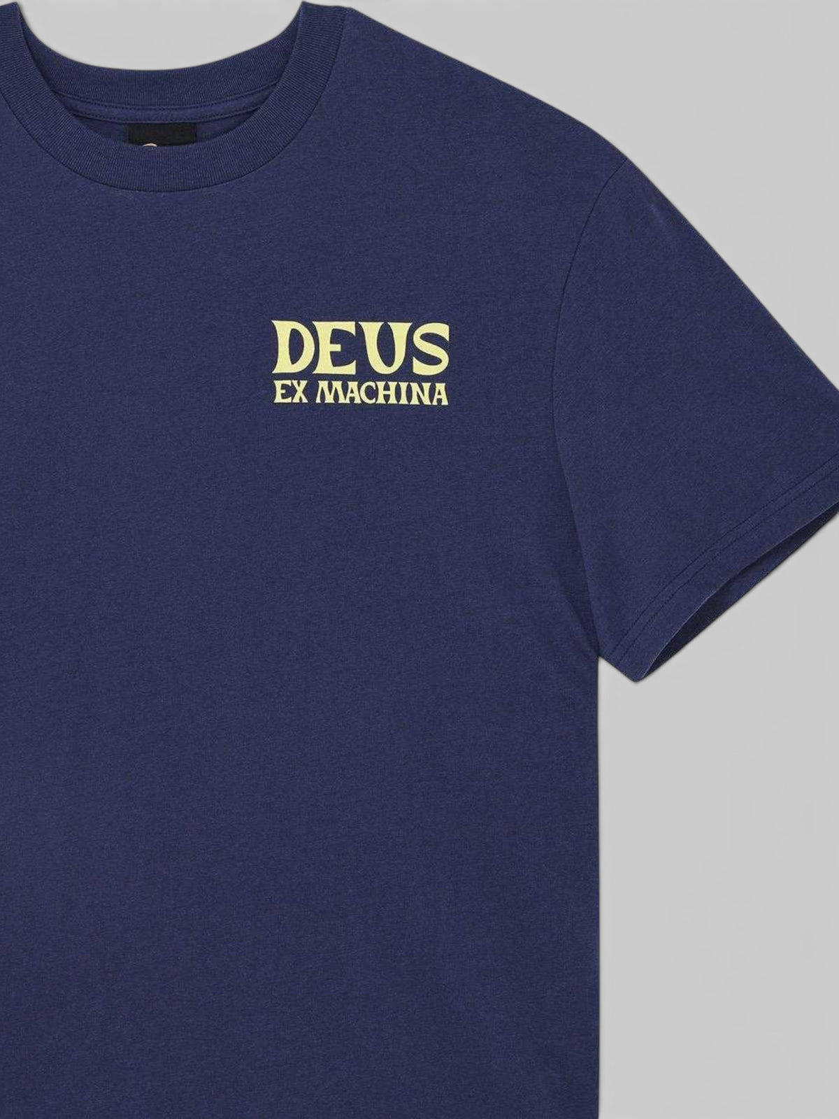 Baffle Haus Chinook Tee in mechanic blue featuring a yellow Deus Ex Machina chest logo on recycled cotton blend