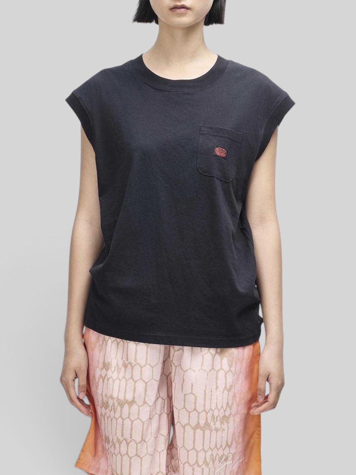 Baffle Haus Christine black cap sleeve tank top with a chest pocket and ribbed neckline on a model