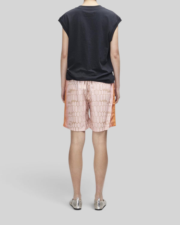Baffle Haus Christine tank in black worn with patterned pink shorts, back view showing cap sleeve and ribbed neck