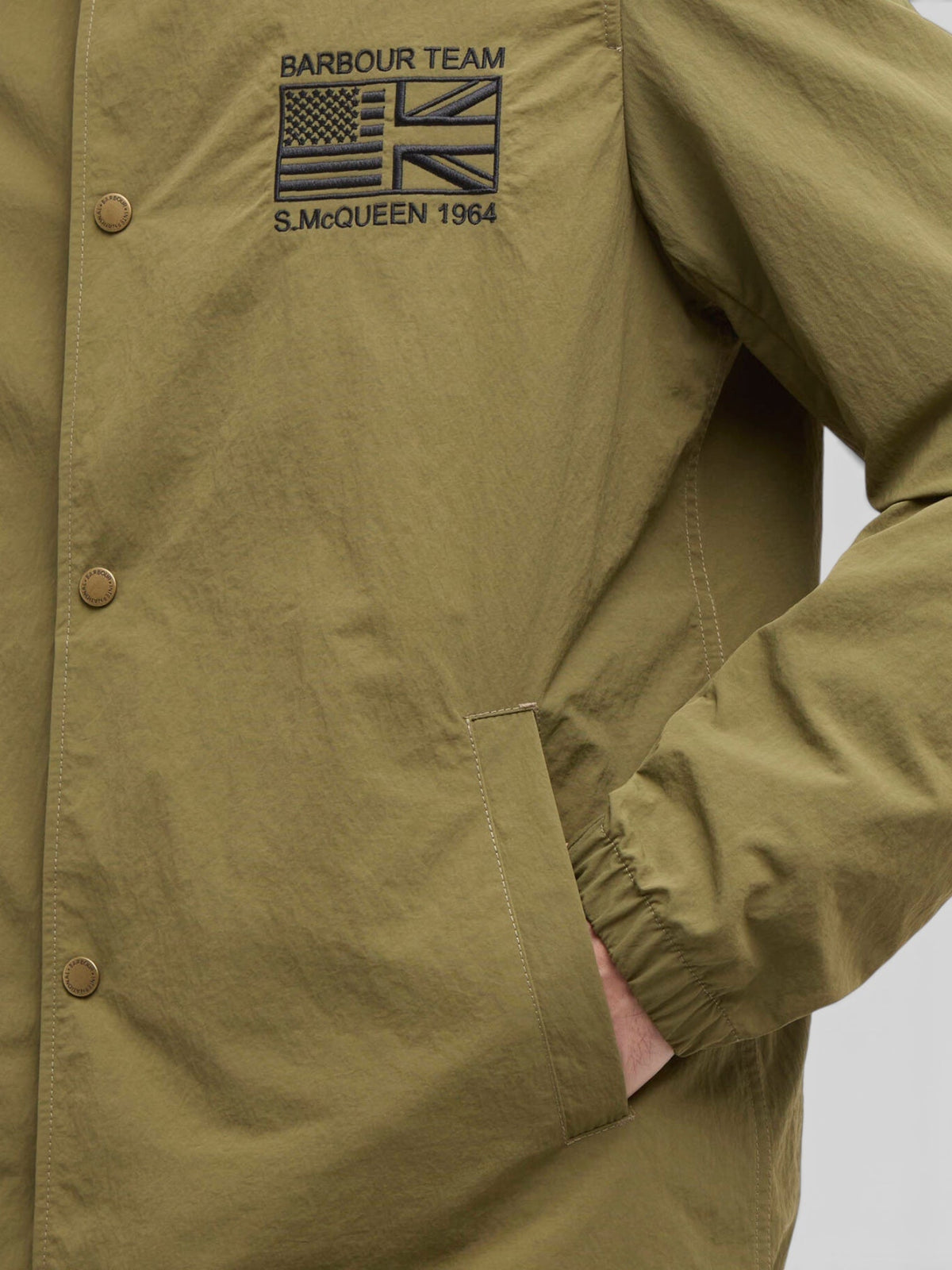 Baffle Haus International Coach Casual Jacket in burnt olive with Steve McQueen embroidery and stud front fastening