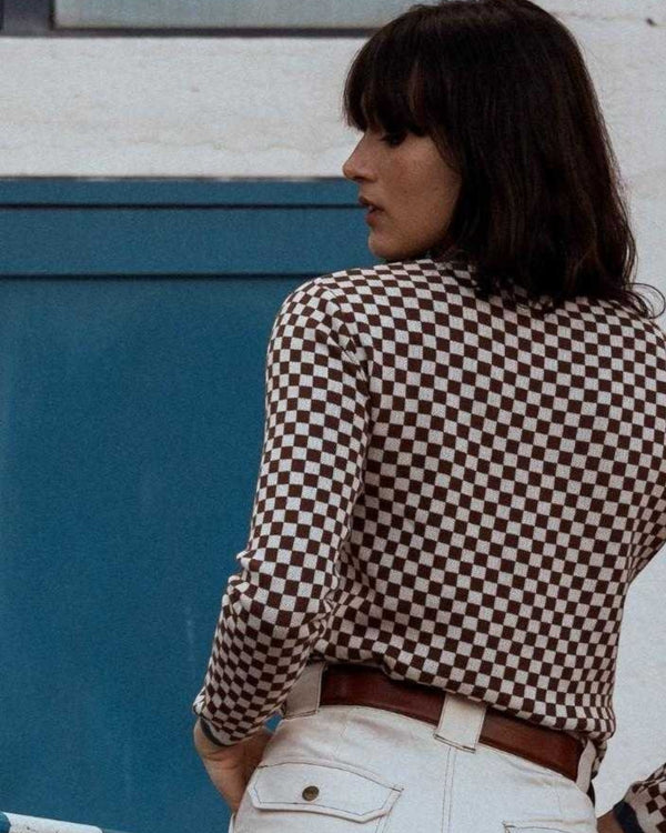 Baffle Haus coffee brown and beige checkerboard cotton knit jumper worn by a woman, vintage racing style