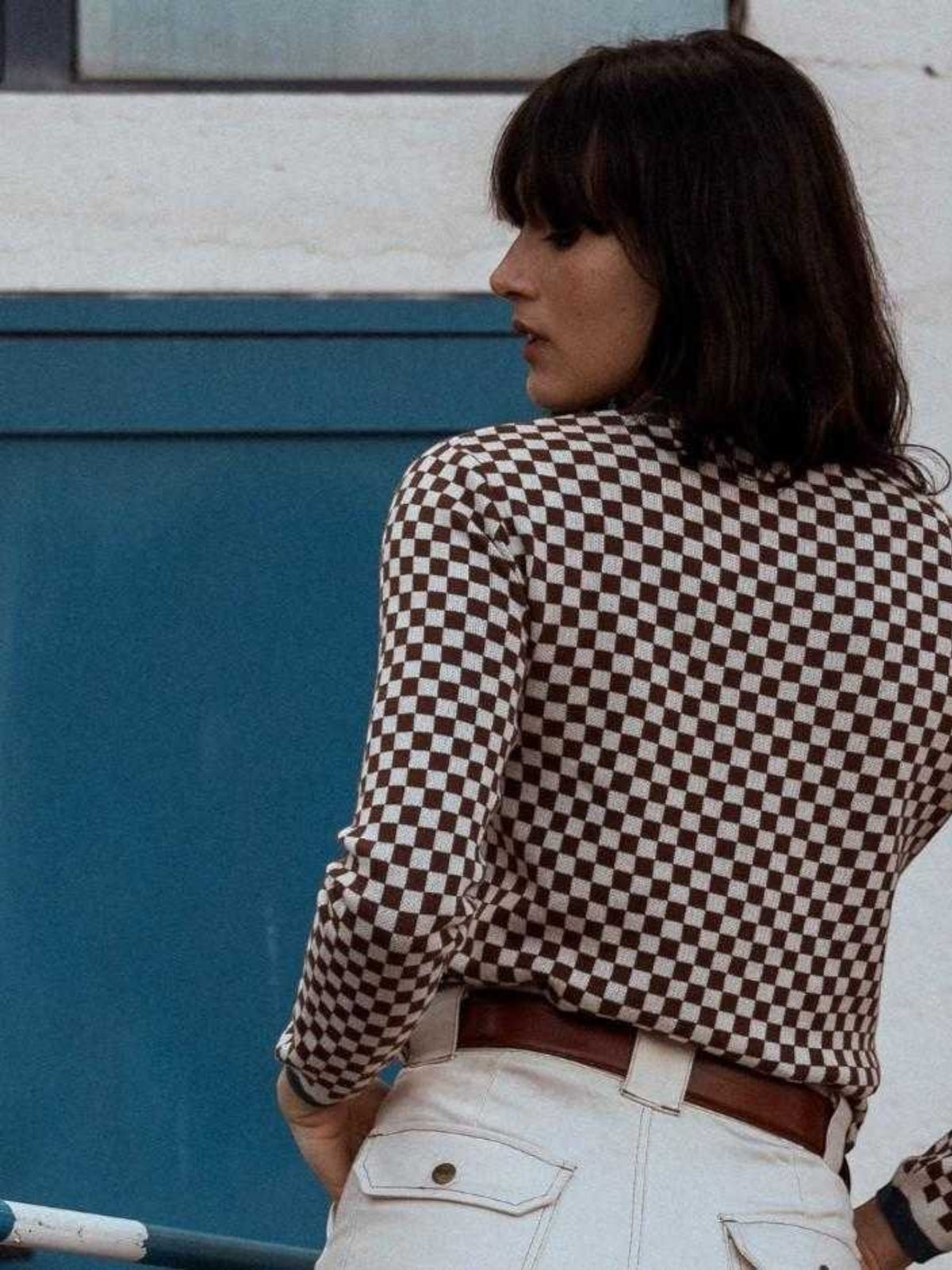 Baffle Haus coffee brown and beige checkerboard cotton knit jumper worn by a woman, vintage racing style