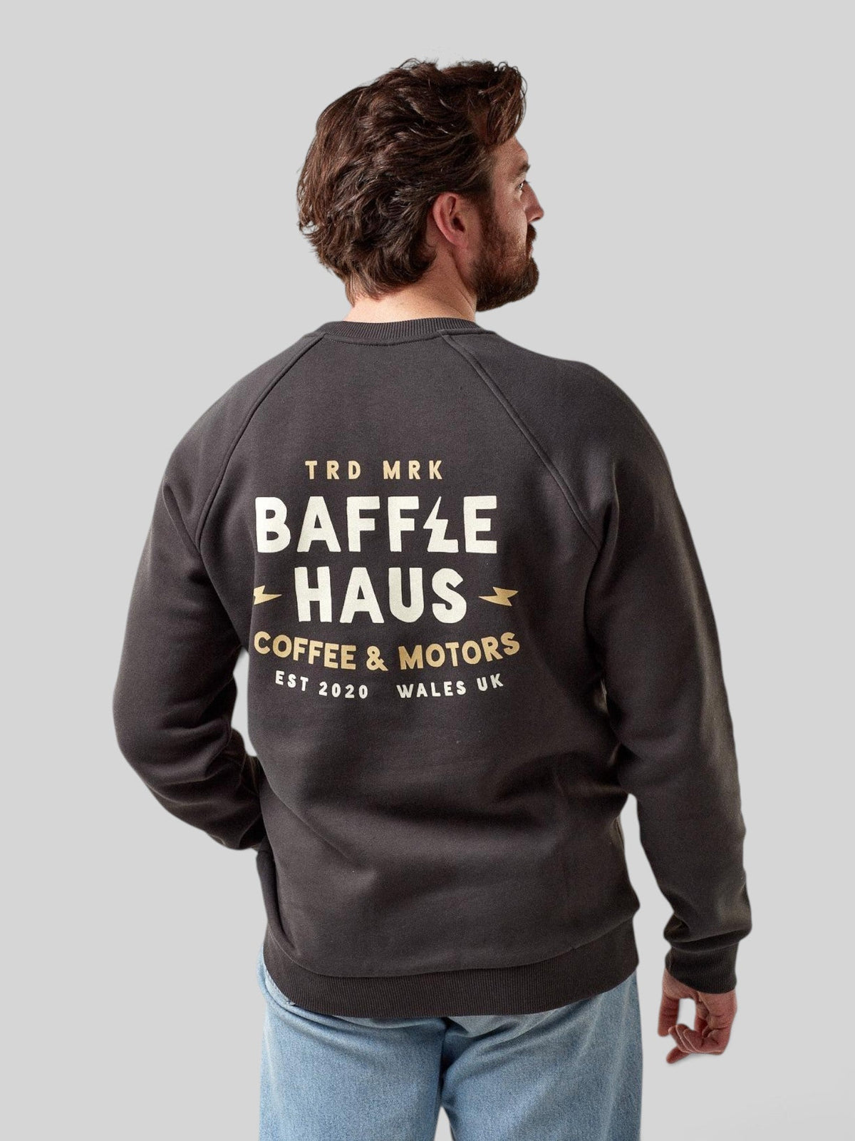 Baffle Haus Coffee & Motors sweatshirt in printers ink grey with back graphic print worn by a man