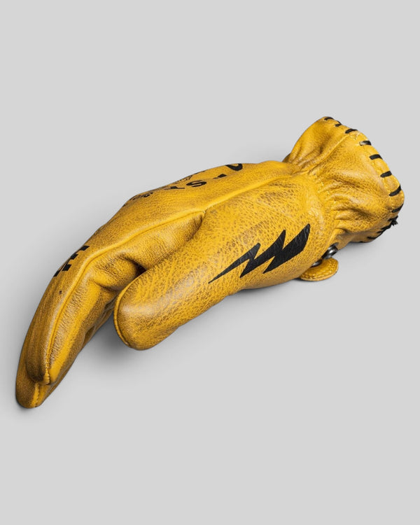 Baffle Haus Coyote yellow cowhide leather motorcycle gloves with black lightning bolt detail and retro short cuff