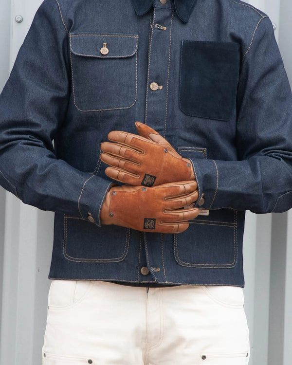 Baffle Haus Age of Glory Crafter gloves in caramel cowhide leather with suede panels worn by a rider in denim jacket