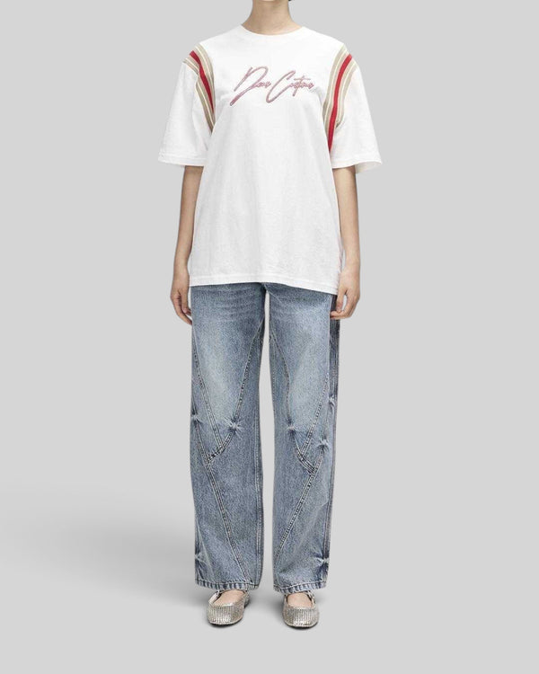 Baffle Haus Debute Tee in antique white with red and beige sleeve stripes and front embroidery on a female model