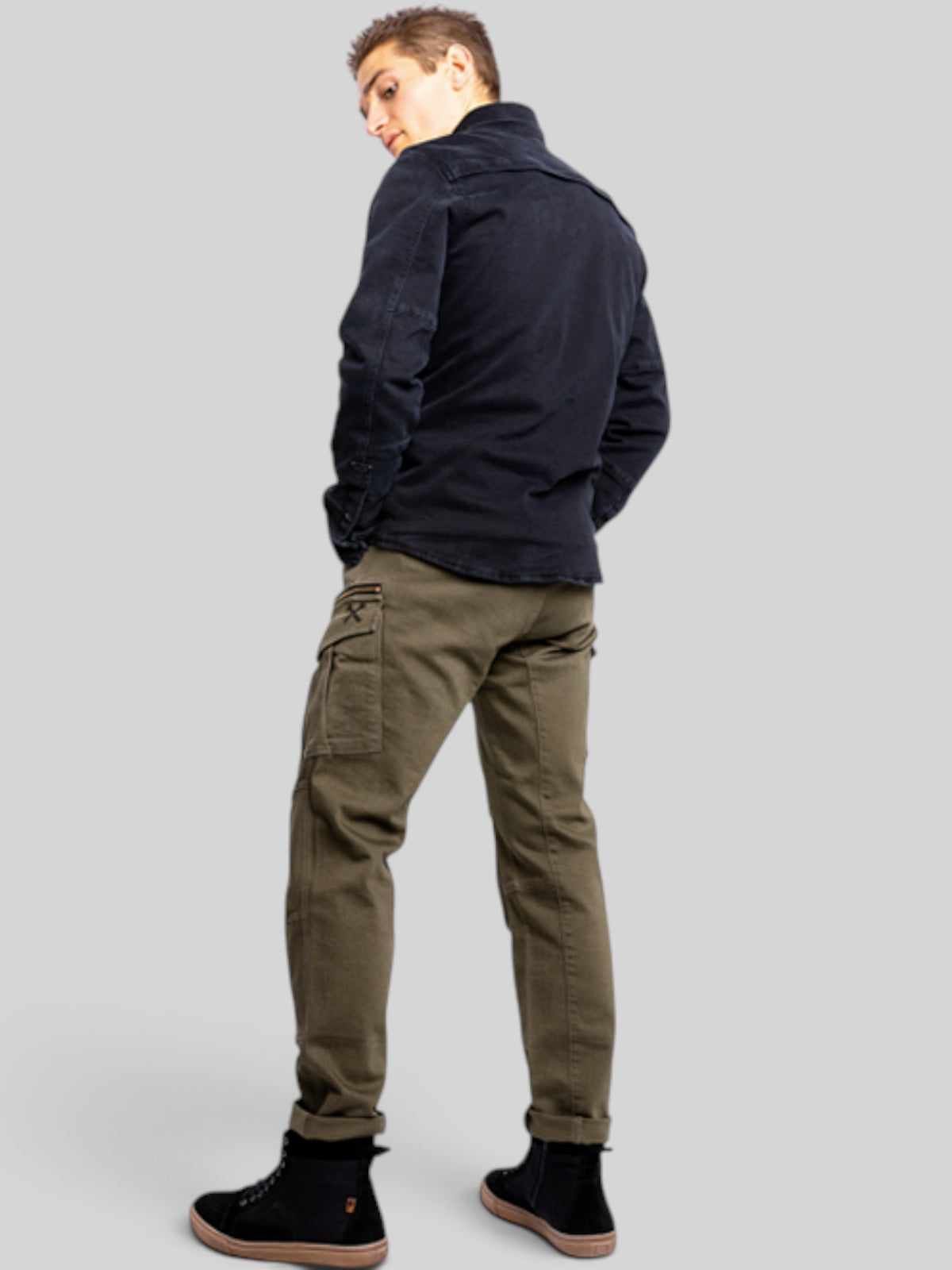 Baffle Haus Defender Mono olive cargo motorcycle jeans with slim fit and side pockets worn by a man from behind