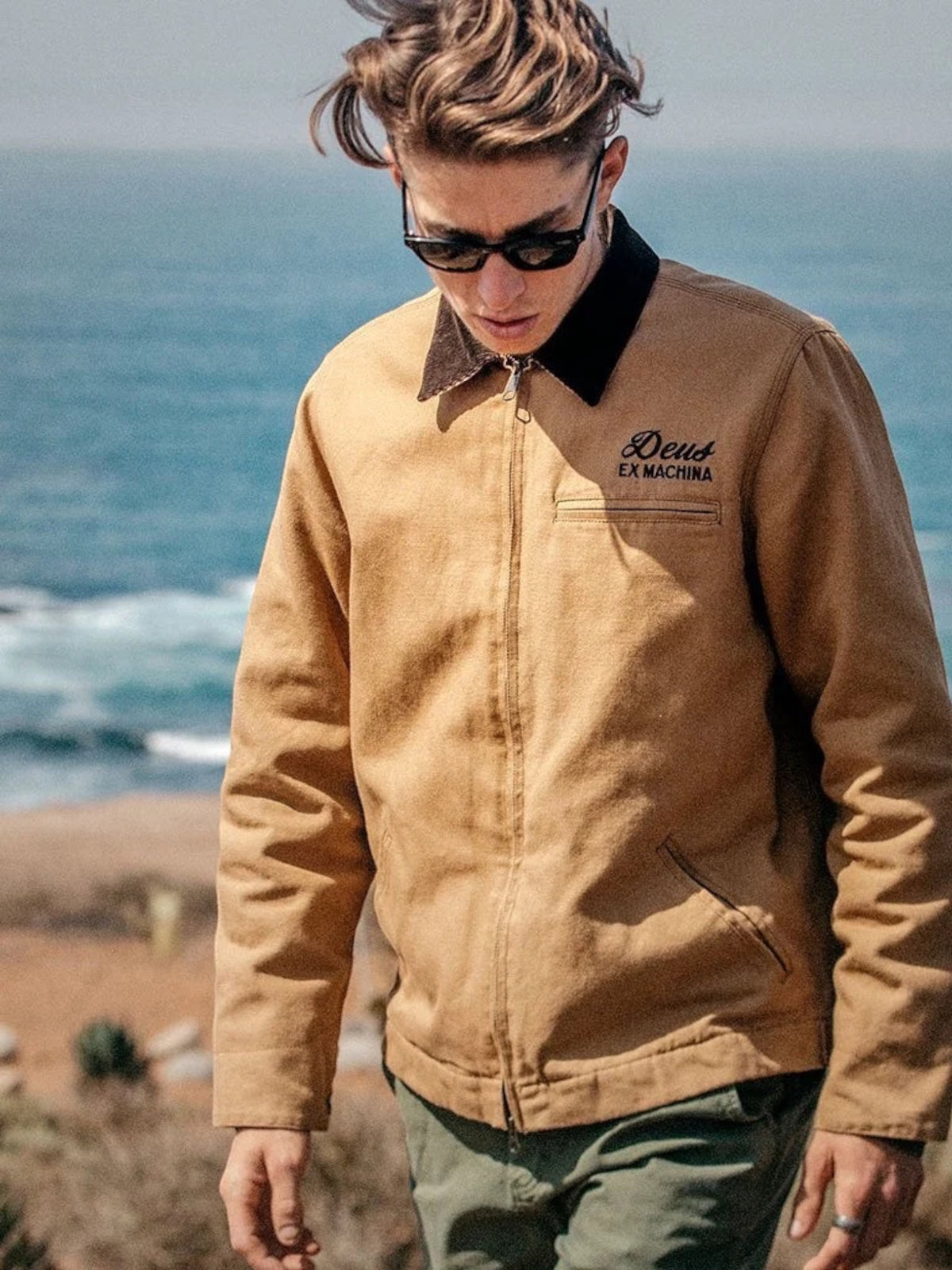 Baffle Haus dijon tan cotton canvas workwear jacket with zip closure and embroidered Deus Ex Machina logo