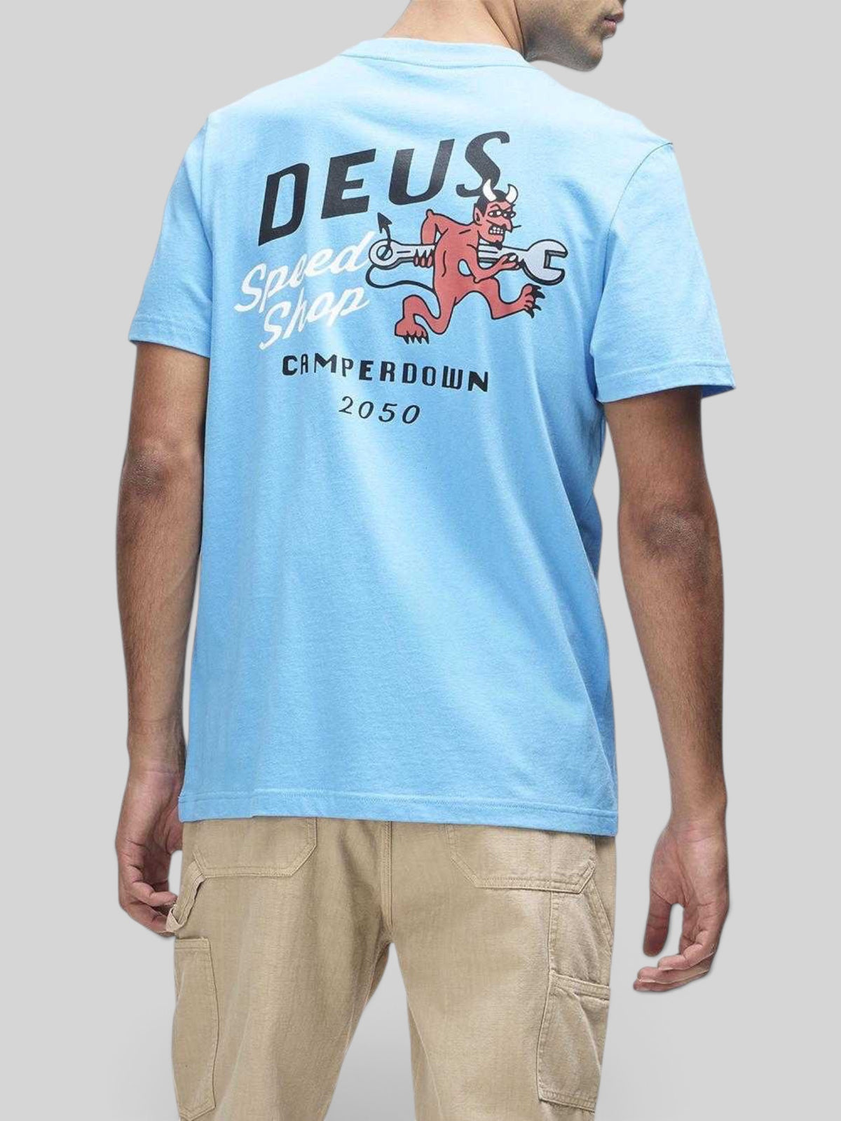 Baffle Haus Dogleg Tee in bonnie blue featuring a graphic print of a devil with a wrench on the back