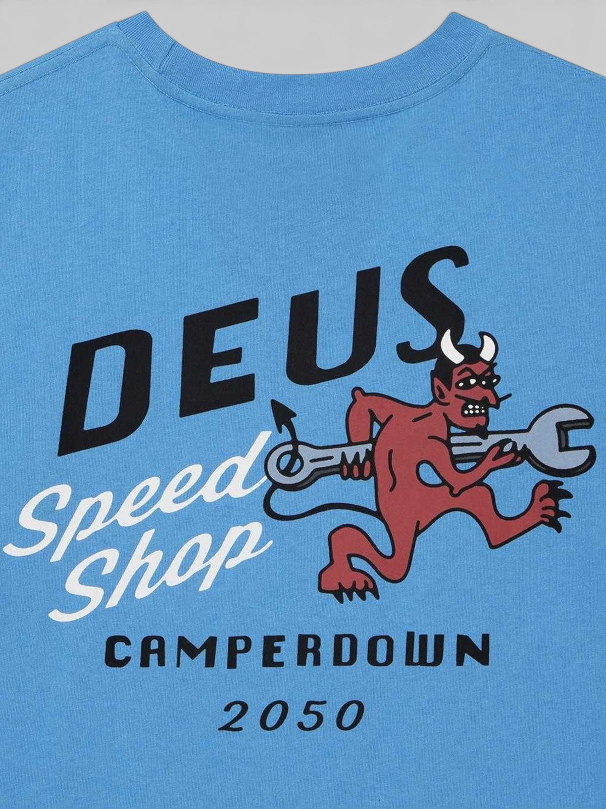Baffle Haus Dogleg Tee in Bonnie Blue featuring a graphic print of a red devil holding a wrench on organic cotton