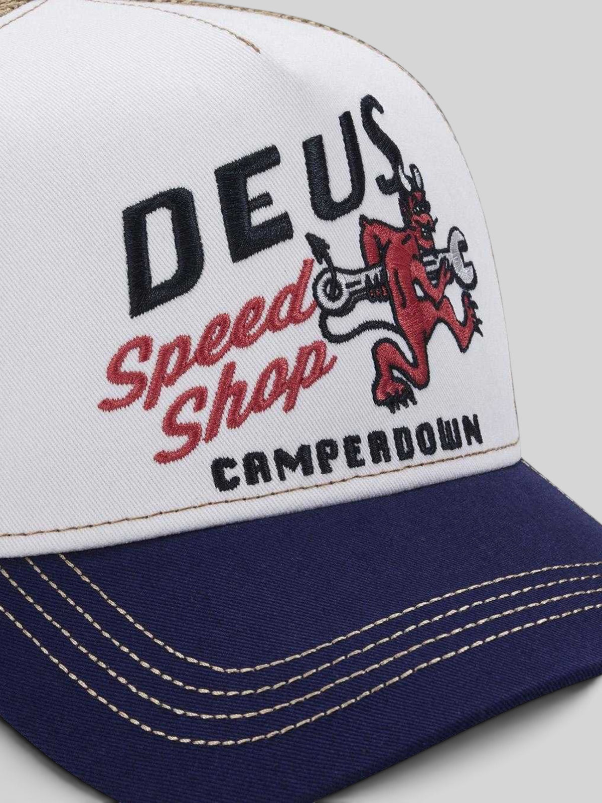 Baffle Haus Dogleg Trucker hat in dirty white with navy brim and red devil graphic embroidery