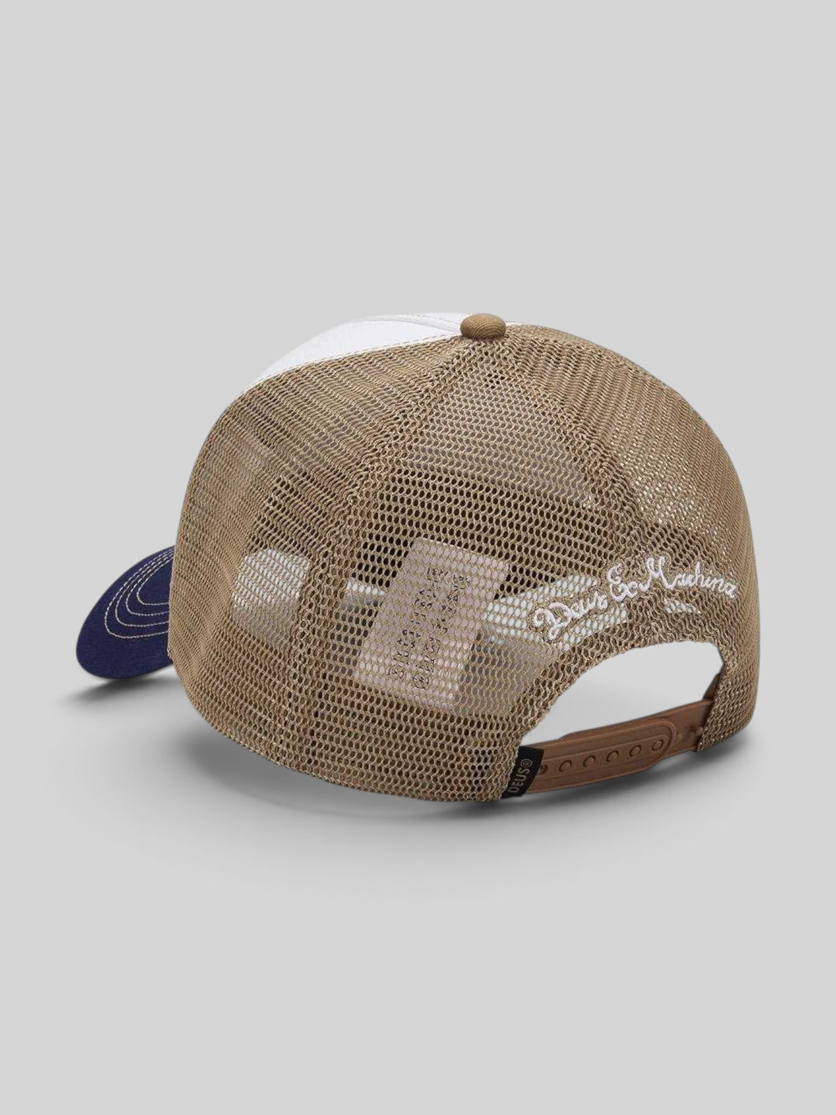 Baffle Haus Dogleg Trucker hat in dirty white and tan with mesh back and Deus Ex Machina embroidery