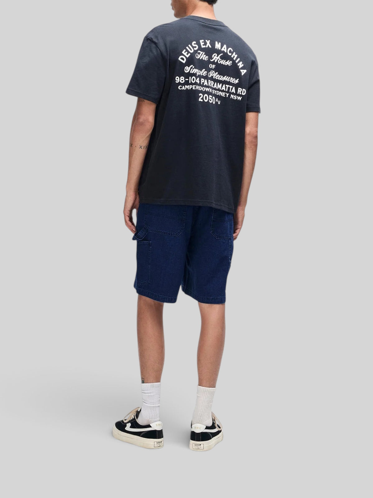 Baffle Haus Drovers Dog black organic cotton t-shirt with graphic back print worn with dark denim shorts