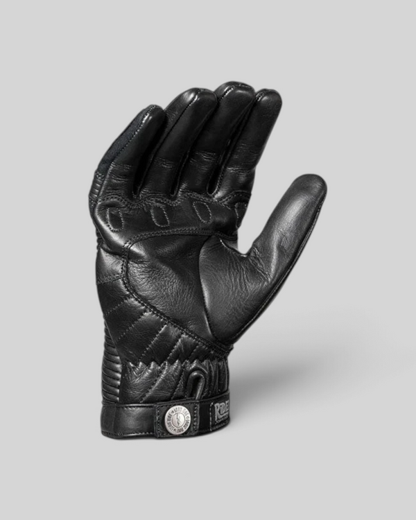 Baffle Haus Durango black leather motorcycle gloves with XTM-Fiber lining, padded fingers, and press stud closure.