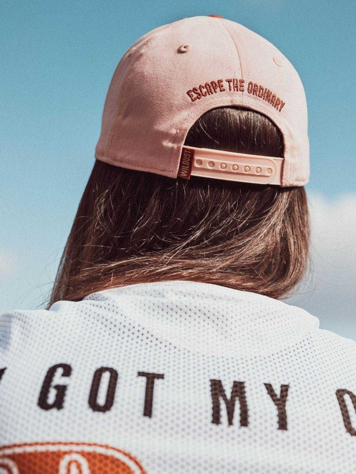 Baffle Haus woman racer cap in dusty pink with Escape the Ordinary embroidery and adjustable snapback closure