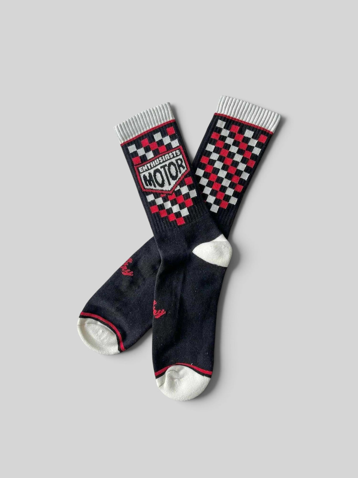 Baffle Haus Age Of Glory Enthusiasts socks in black, red, and off-white with a vintage checkered motorcycle design.