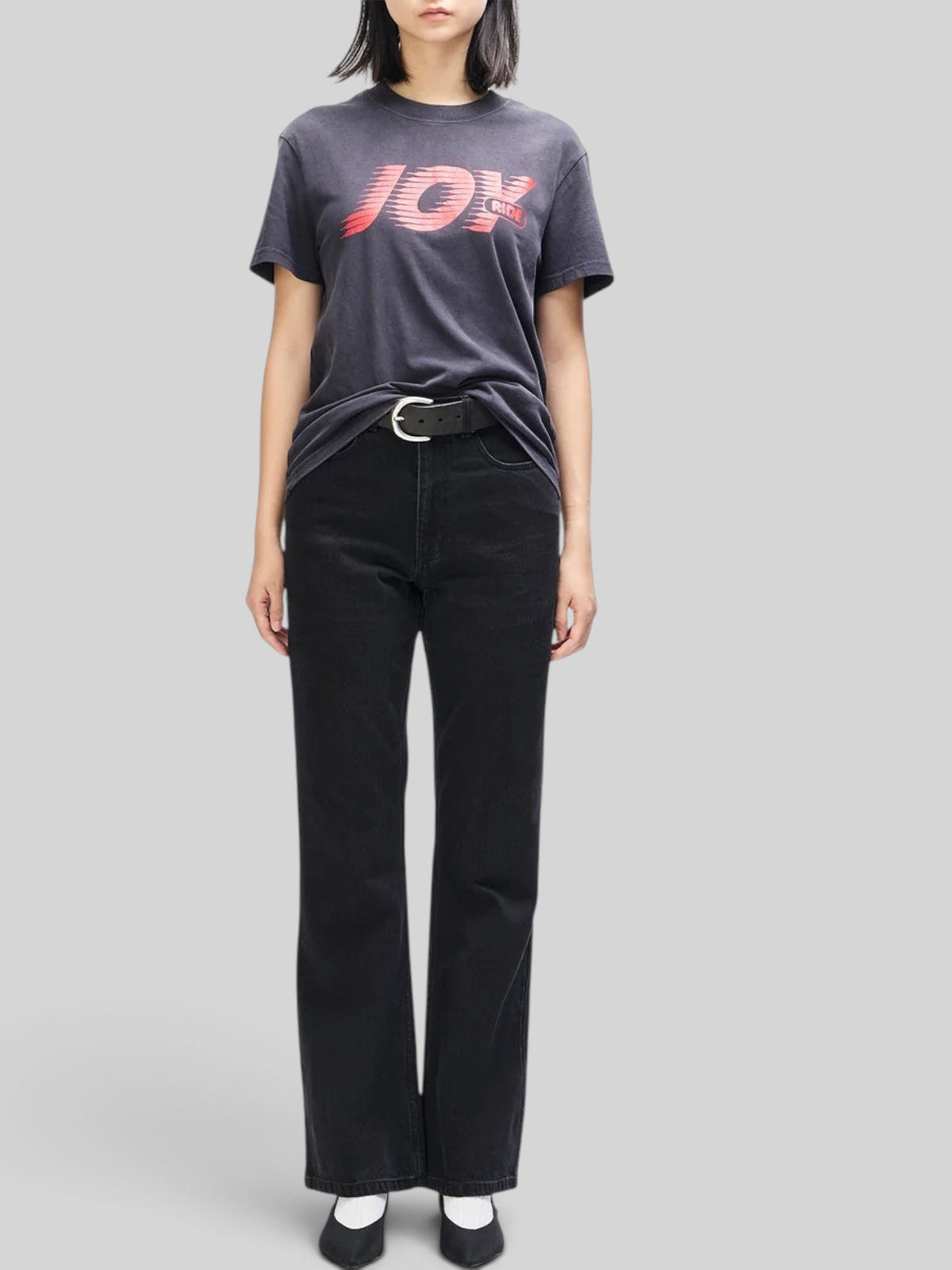 Baffle Haus vintage fit black pigment dyed cotton t-shirt with red graphic chest print worn by a model